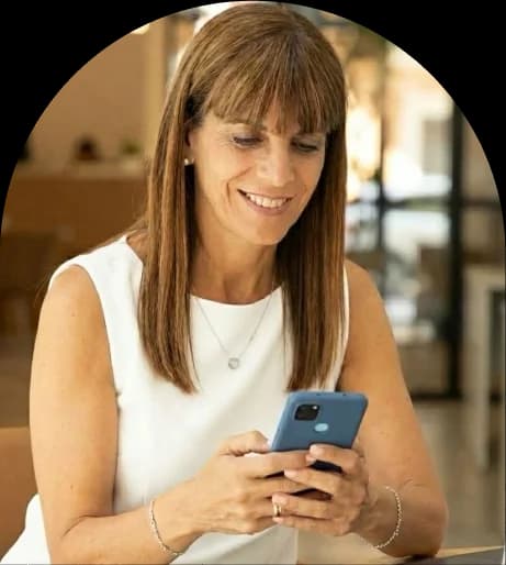 Smiling professional woman browsing furnished apartment listings on smartphone - Globexs relocation consultant helping expats find housing in Spain