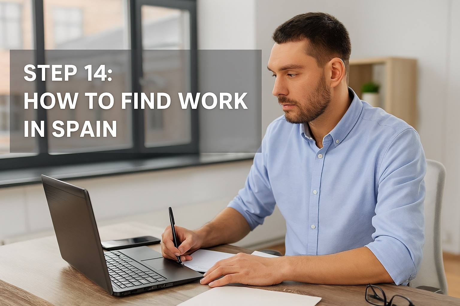 Young man working on laptop and writing notes in modern office – Step 14: How to find work in Spain after relocating