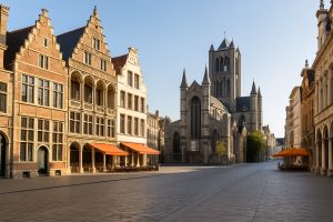 Sunlit cobblestone street in Ghent, Belgium, featuring historic Flemish architecture and classic facades — a peaceful European cityscape ideal for expat relocation.